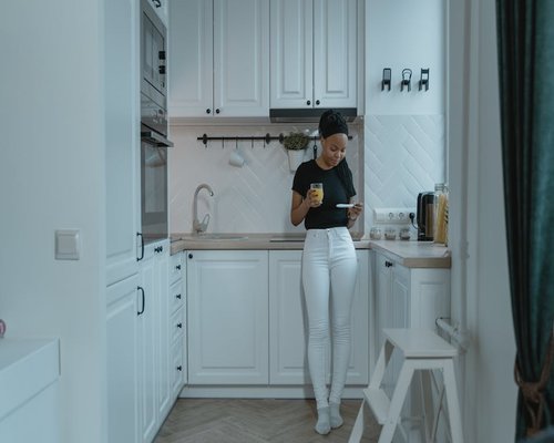 Person arranging objects comfortably in their home kitchen